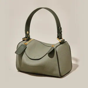 Green leather pillow handbag for women, versatile Boston shoulder bag with top handle and strap.