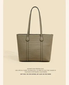 Close-up view of the elegant faux-croc tote bag showing detailed texture and sturdy handles.