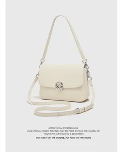 Cream white leather shoulder bag detail, stylish silver braided clasp, elegant minimalist design.