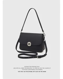 Detailed view of the stylish genuine leather shoulder bag featuring a silver metal knot buckle.