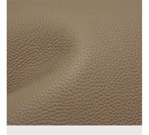 Close-up detail shot of premium pebbled genuine leather texture in elegant taupe color.