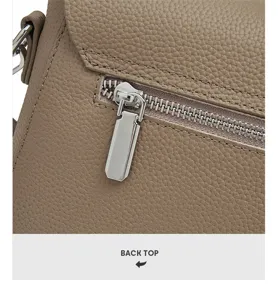 Detailed view of genuine leather bag back zipper pocket with fine texture and metal hardware.