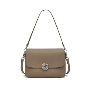 Elegant genuine leather shoulder bag for women with stylish metal knot clasp and strap.