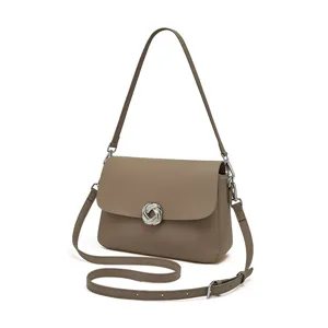 Elegant taupe leather shoulder bag for women, featuring a chic twisted knot clasp and dual straps.