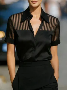 Close-up detail of the black satin short sleeve blouse with sheer vertical stripe pattern.
