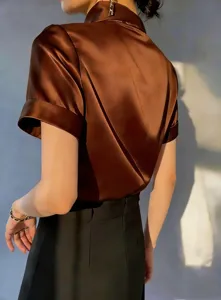 Close-up detail of the elegant brown satin short-sleeve shirt showcasing smooth texture.