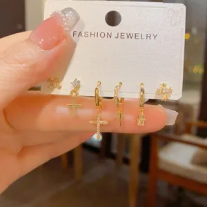 Detail shot of a fashion gold-plated zircon cross earring set featuring sparkling rhinestone details.