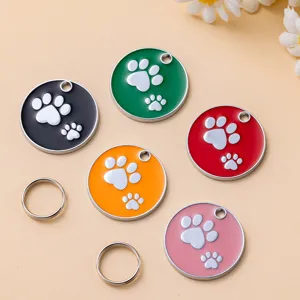 Colorful round metal pet ID tags with cute paw print design and split rings, main view.
