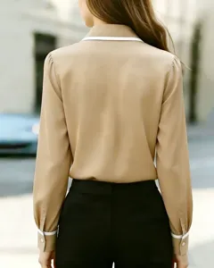 Back view of a chic camel long sleeve blouse featuring a white contrast collar and cuffs.