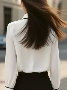 Detail view of the women's contrast lapel long sleeve shirt back design, elegant style.