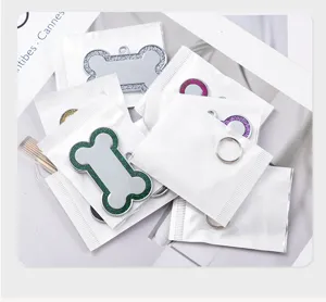 Glitter bone-shaped pet ID dog tag detail, metal anti-lost pendant in protective bag.