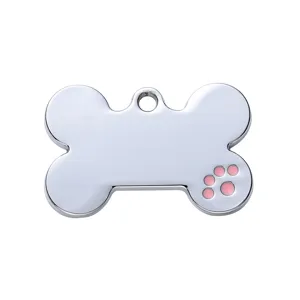 Silver metal bone pet ID tag with pink enamel paw print, ideal for custom dog and cat name tags.