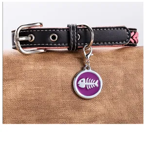 Detailed shot of cute fishbone pet collar, black pink leather with metal tag for dogs and cats.