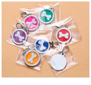 Close-up detail of colorful round metal dog tags with bone design, epoxy and electroplating finish.