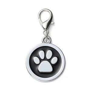 Round metal pet ID tag with black epoxy paw print design and secure lobster clasp attachment.