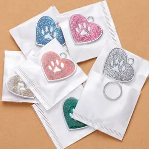 Heart-shaped glitter pet dog tag with paw print design, metal pendant accessories.