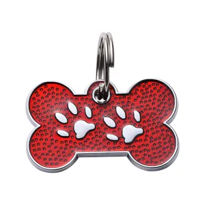 Red bone shape pet ID tag for dogs and cats with cute white paw prints and metal split ring.