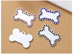 Close up view of sparkly rhinestone pet ID tags in cute bone shape, metal dog pendant details.