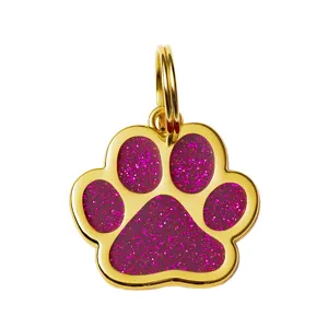 Gold pet ID tag with sparkling magenta paw print design, durable metal charm for dogs.