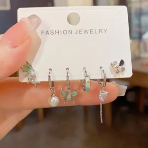 Detailed view of trendy gradient butterfly earring set, chic metallic huggie hoops for women