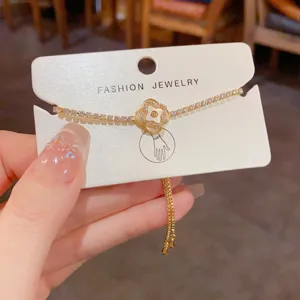 Minimalist four leaf clover bracelet with sparkling rhinestones and adjustable pull chain.