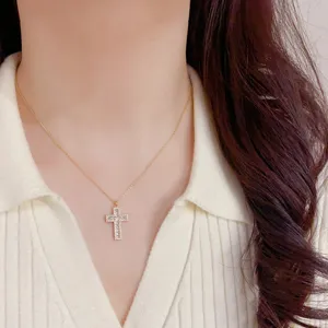 Elegant zircon cross pendant necklace with sparkling stones on delicate gold chain for chic wear.
