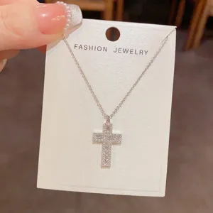 Silver zircon cross pendant necklace on display card, exquisite and elegant fashion jewelry.