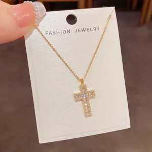 Exquisite gold-plated cross pendant necklace featuring sparkling zircon stones for elegant daily wear.