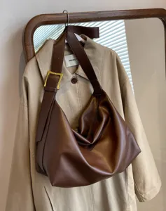 Brown slouchy PU leather shoulder bag detail, large capacity hobo crossbody design, chic aesthetic.