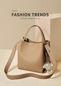 Detailed view of the stylish khaki textured bucket bag with shoulder strap and plush charm.