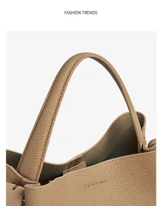 Detailed close-up of premium pebbled leather handbag handle with fine stitching and hardware.
