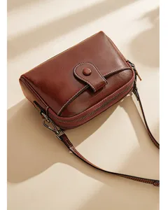 Elegant brown leather crossbody shoulder bag detail, minimalist design, lightweight daily wear.