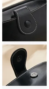 Black genuine leather women shoulder bag detail shot with white stitching and magnetic snap.