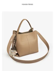 Stylish leather bucket bag with cute hedgehog pendant, versatile crossbody and shoulder handbag.