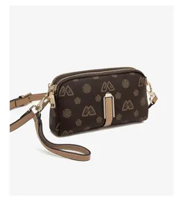 Detailed view of the brown women's crossbody phone bag, showing monogram pattern and chic hardware.