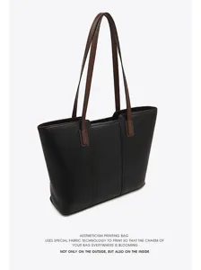 Black leather tote bag for women, large capacity commuter handbag with brown shoulder straps.