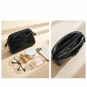 Classic black leather crossbody bag for women, simple multi-compartment shoulder handbag.
