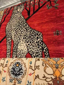 Detailed close-up of a luxury printed area rug featuring a striking leopard and tree motif.