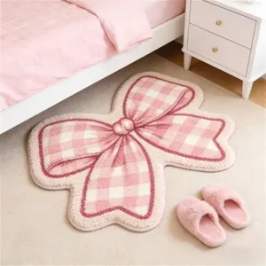 Roze strik gevormd pluche vloerkleed voor slaapkamer, schattig esthetisch deurmat detail shot.