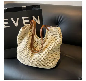 Woven straw shoulder bag for women, casual beach tote with brown leather handles, large capacity.