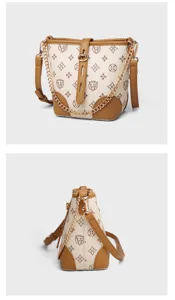 Details of stylish monogram bucket bag with chain strap and contrast brown leather trim.