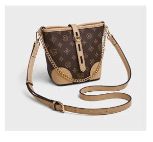 Classic monogram bucket bag with leather trim, shoulder strap and chic chain detail.