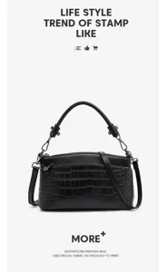 Black crocodile pattern leather handbag detail view, multiple compartments, top handle