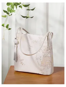 Chinese style jacquard tote bag detailed view, elegant floral pattern with delicate tassel.