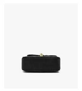 Detailed bottom view of black quilted mini crossbody bag, showing fine texture and gold hardware.