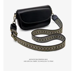 Retro black leather shoulder bag with stylish wide geometric strap, casual crossbody design.