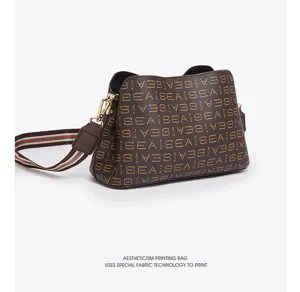 Women stylish brown bucket bag crossbody shoulder bag with print and striped strap daily commute