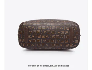 Brown bucket handbag bottom view detail with monogram print and protective feet design.