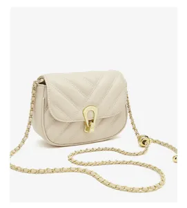 Mini quilted crossbody bag in beige color with chic gold chain strap and elegant metallic clasp detail.