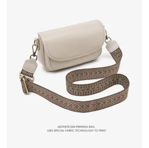 Close-up detail of the vintage beige crossbody bag featuring a unique woven strap and hardware.